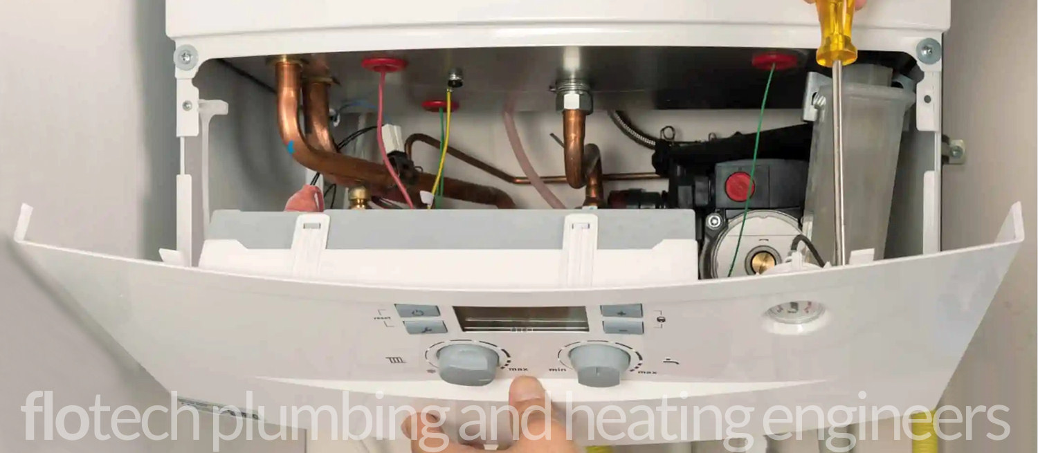 Plumber servicing a central heating boiler in Haverfordwest